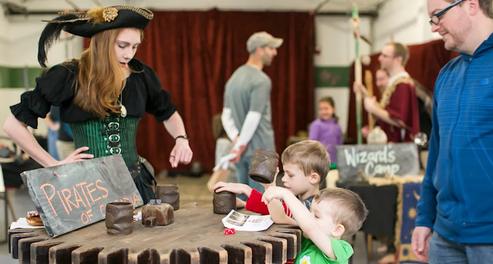 Costumed families at a Trackers community festival booth