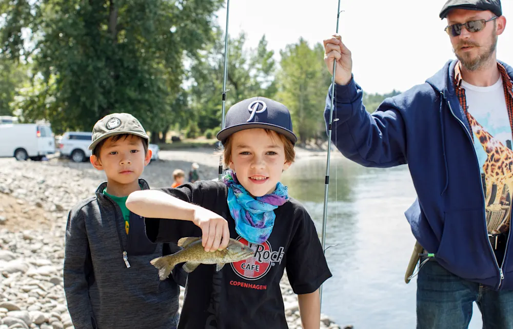 Campers fishing at the river
