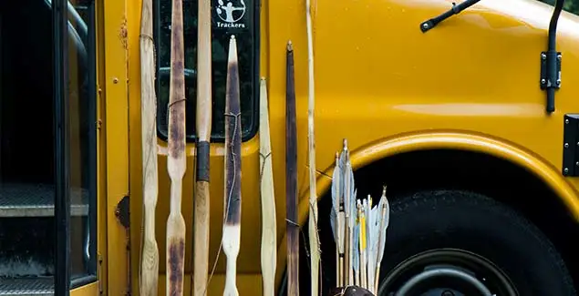 Campers with bows beside the Trackers bus