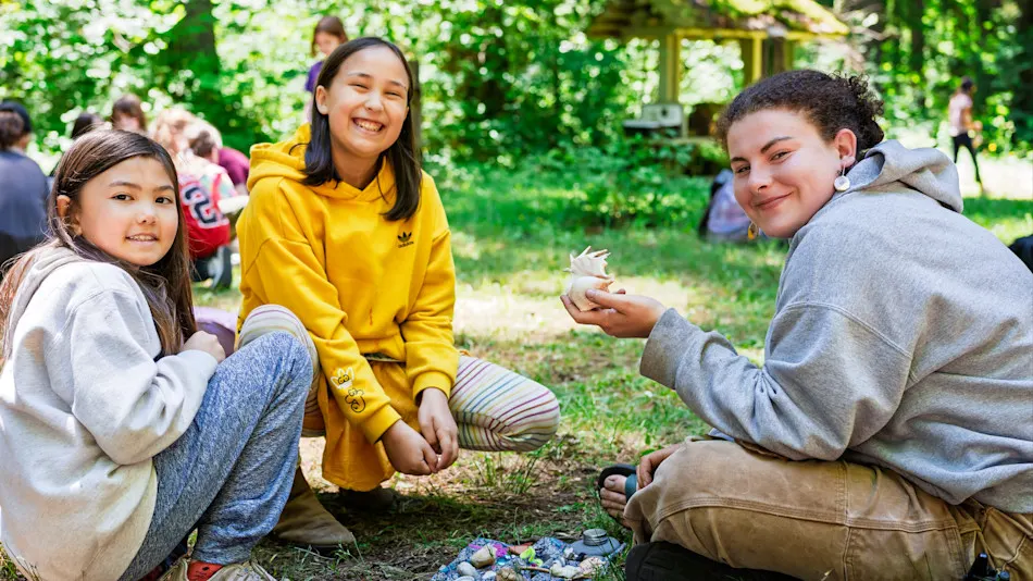 Kids sitting on the ground trading trinkets at the Goblin Market