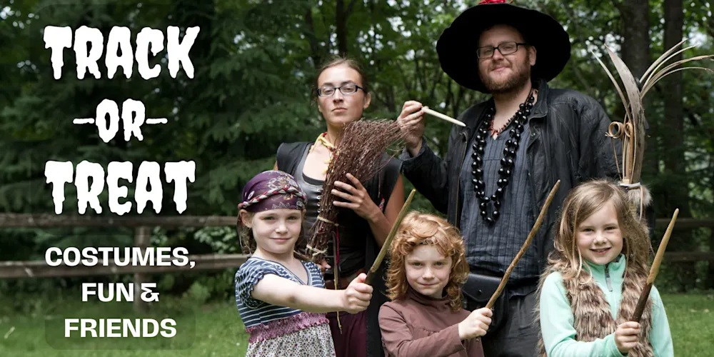 Track-or-Treat: costumed Trackers Guides and kids with bows in the forest